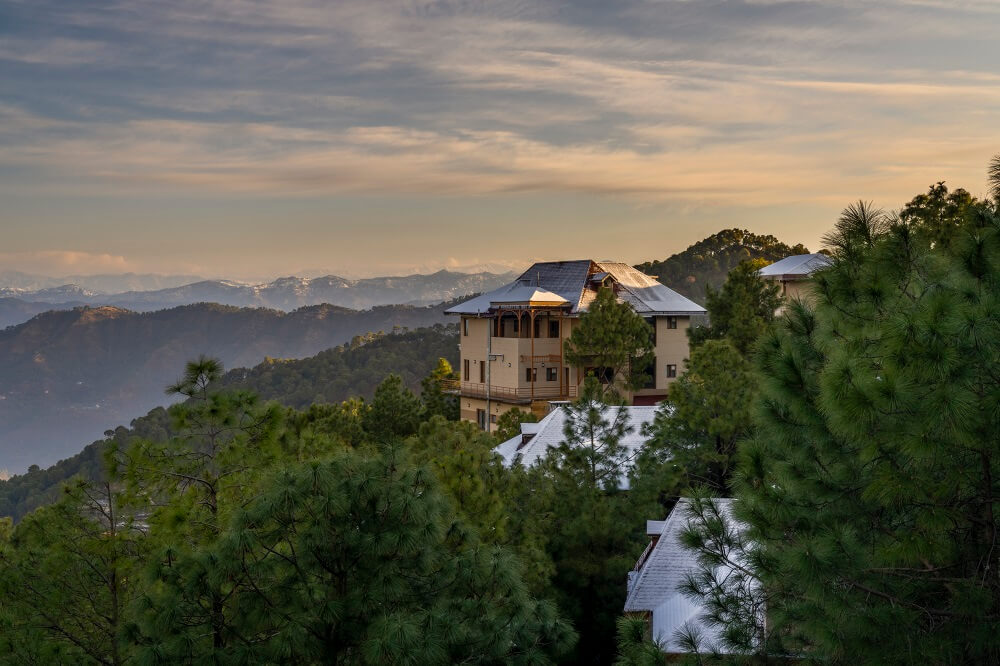 Anantaram Homes villa perched on a hillside with mountain views