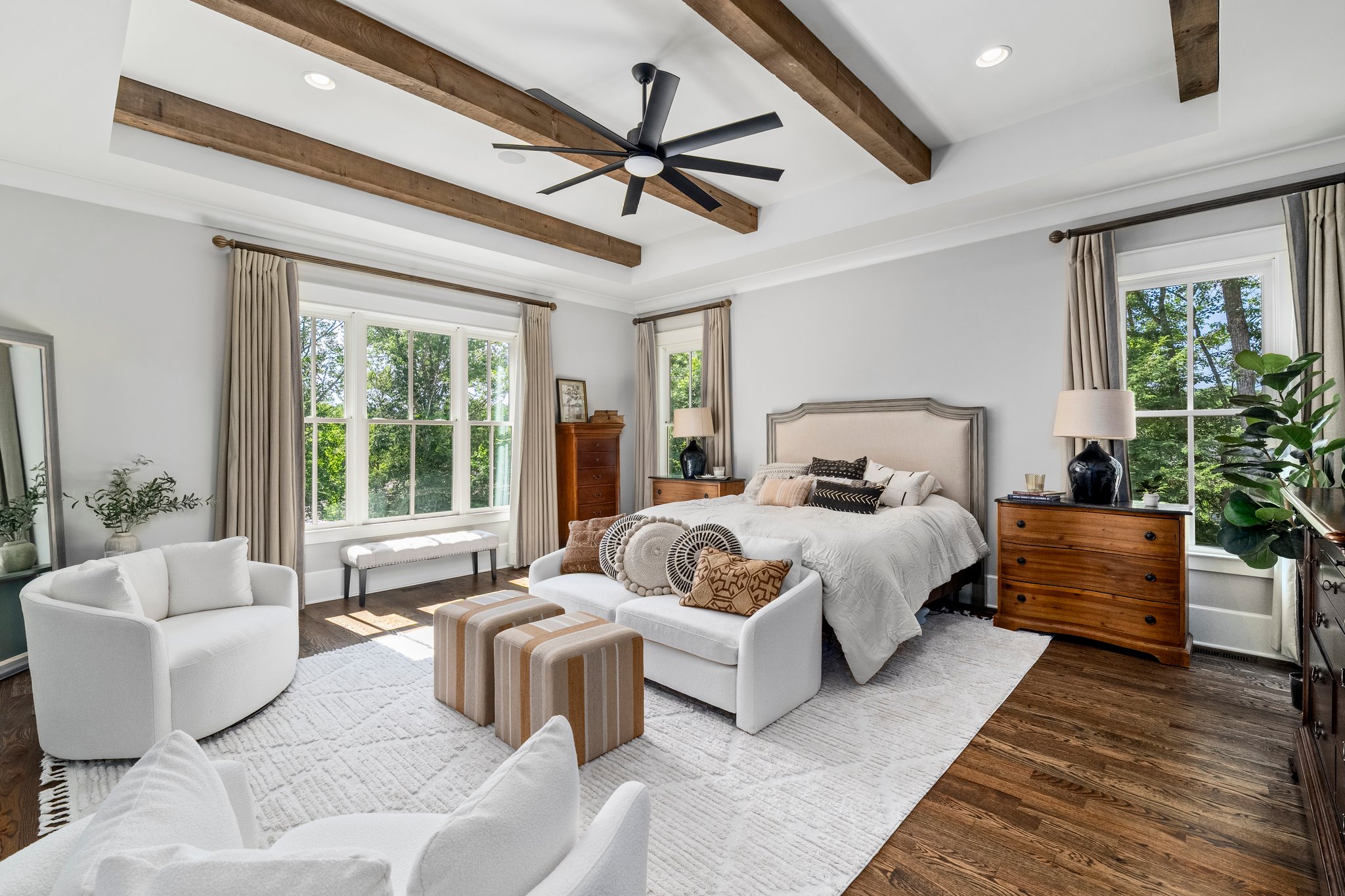 Elegant bedroom with exposed beams and seating area