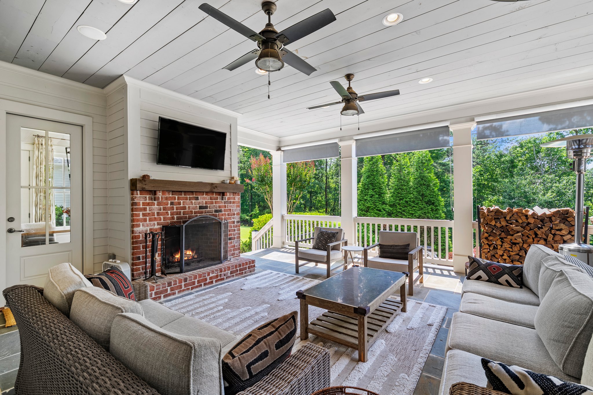 Covered outdoor patio with fireplace and comfortable seating