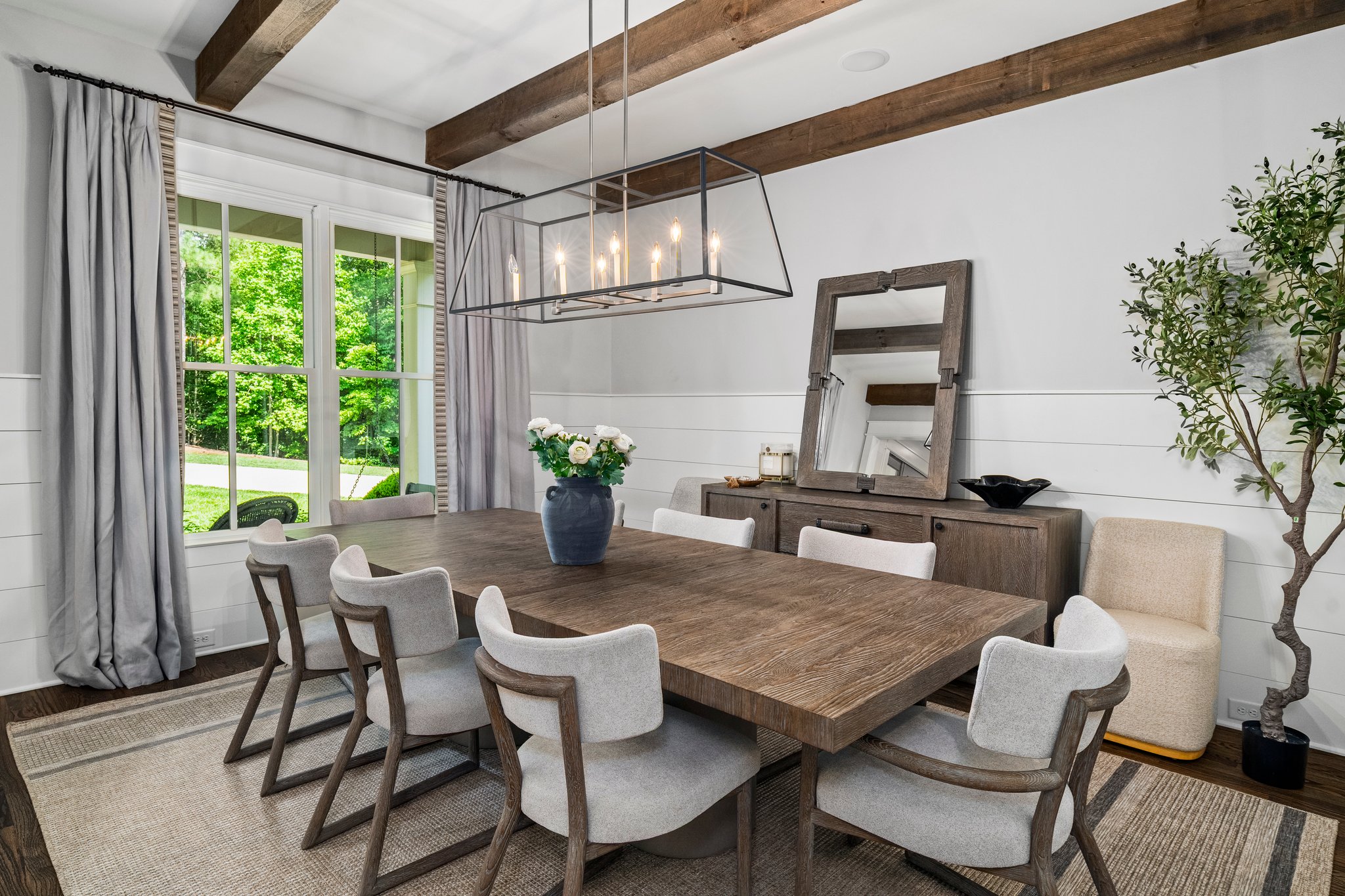 Modern dining room with exposed beams and pendant lighting