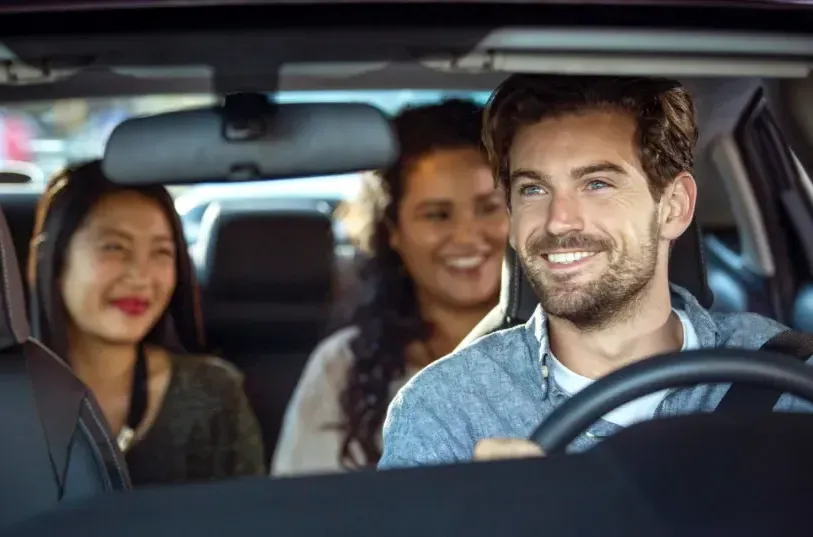 Happy driver with passengers in car