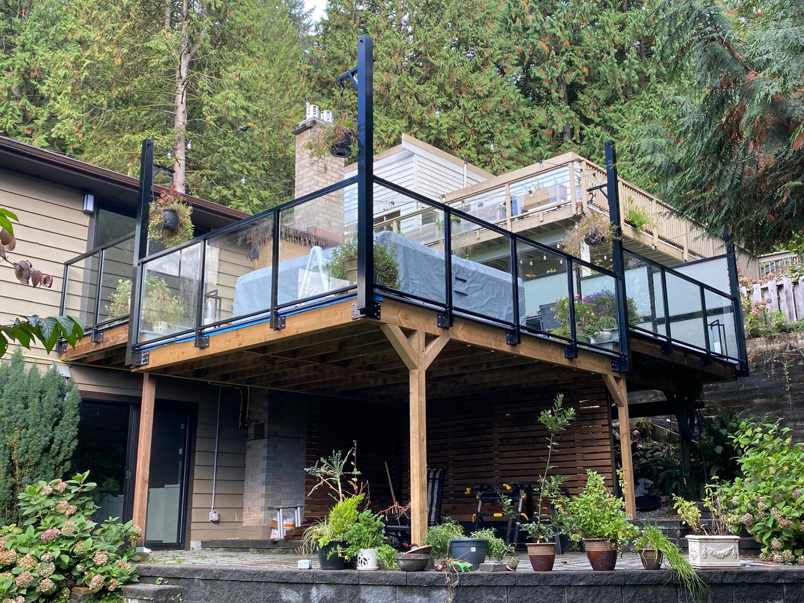 Modern deck with glass railings and wooden structure