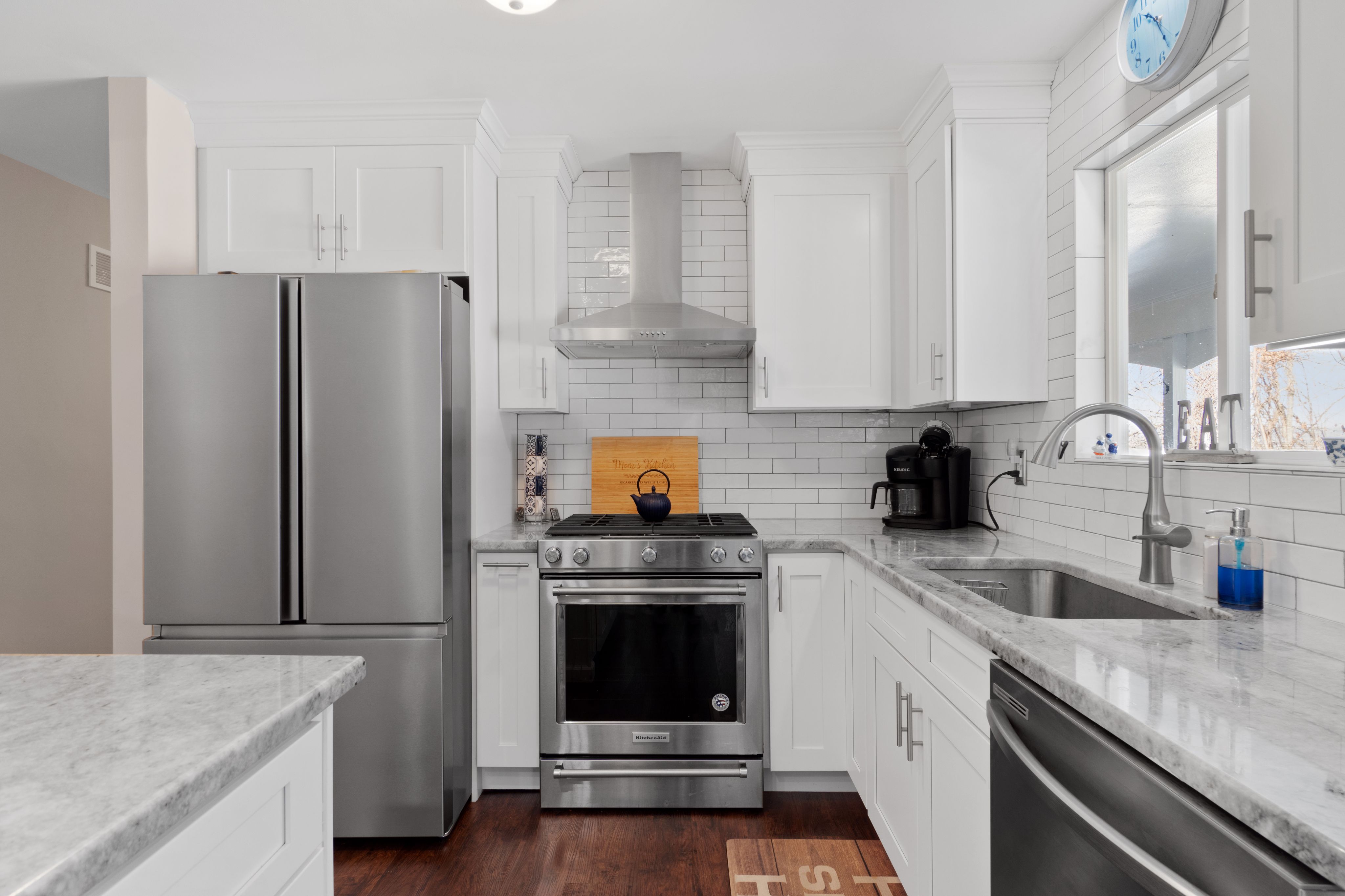 Modern kitchen with white cabinets and stainless steel appliances