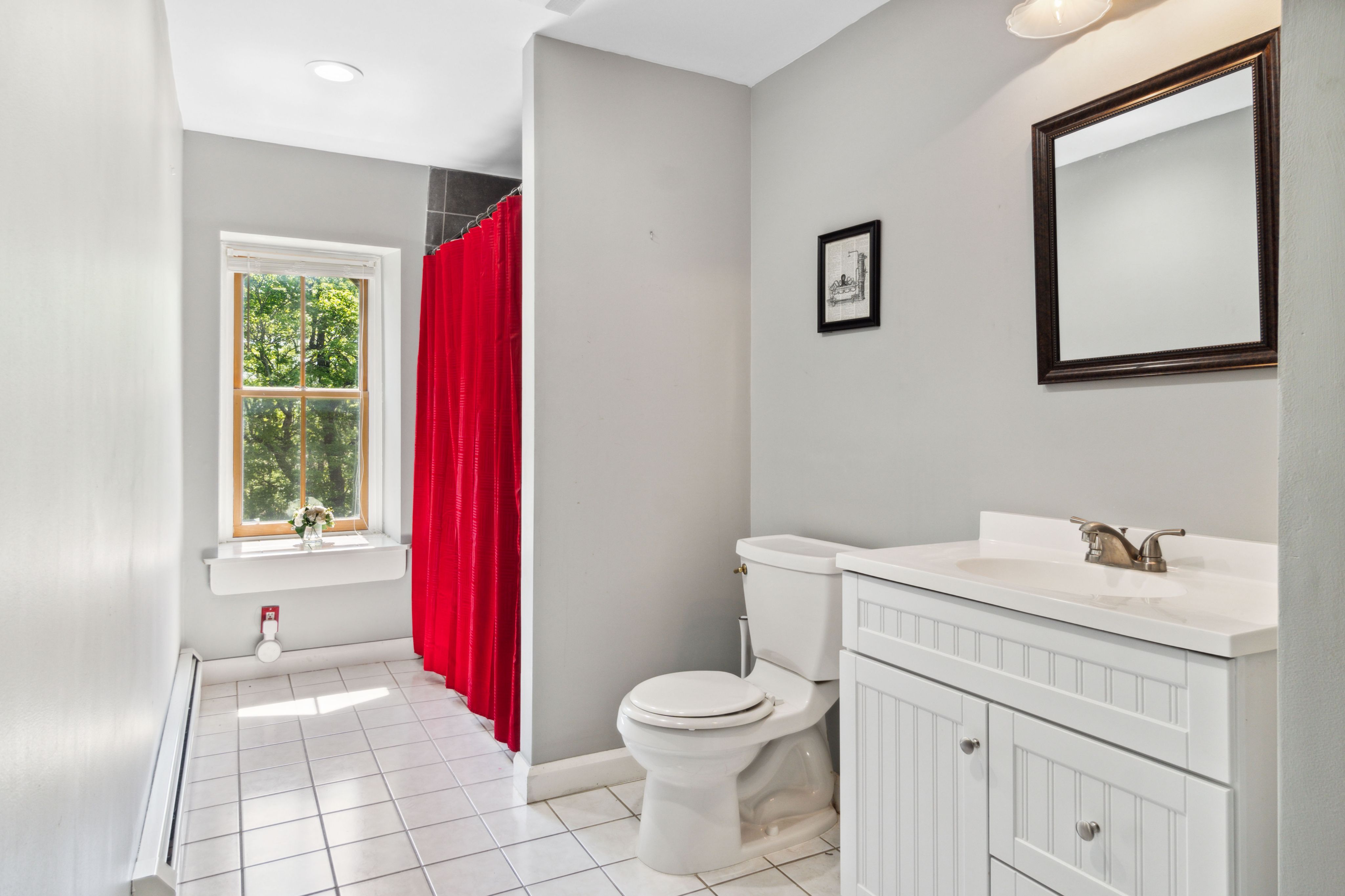 Bathroom with red shower curtain