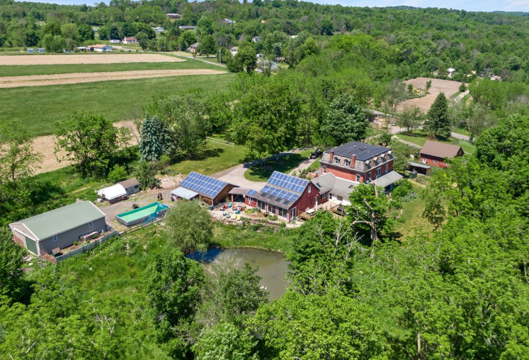 Aerial view of farm property with solar panels