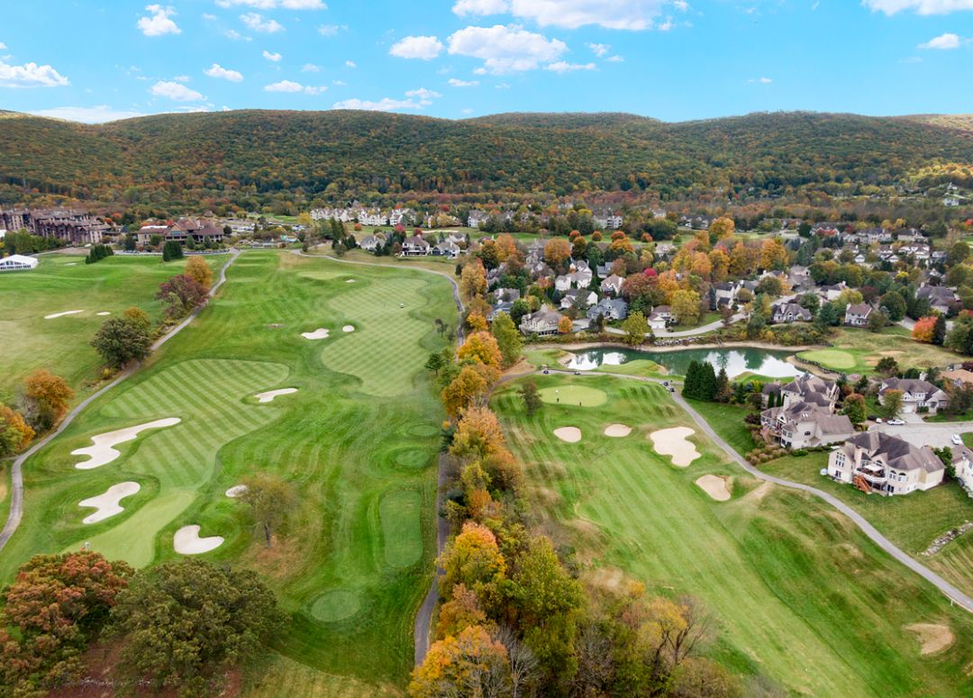 Aerial view of golf course with fall foliage