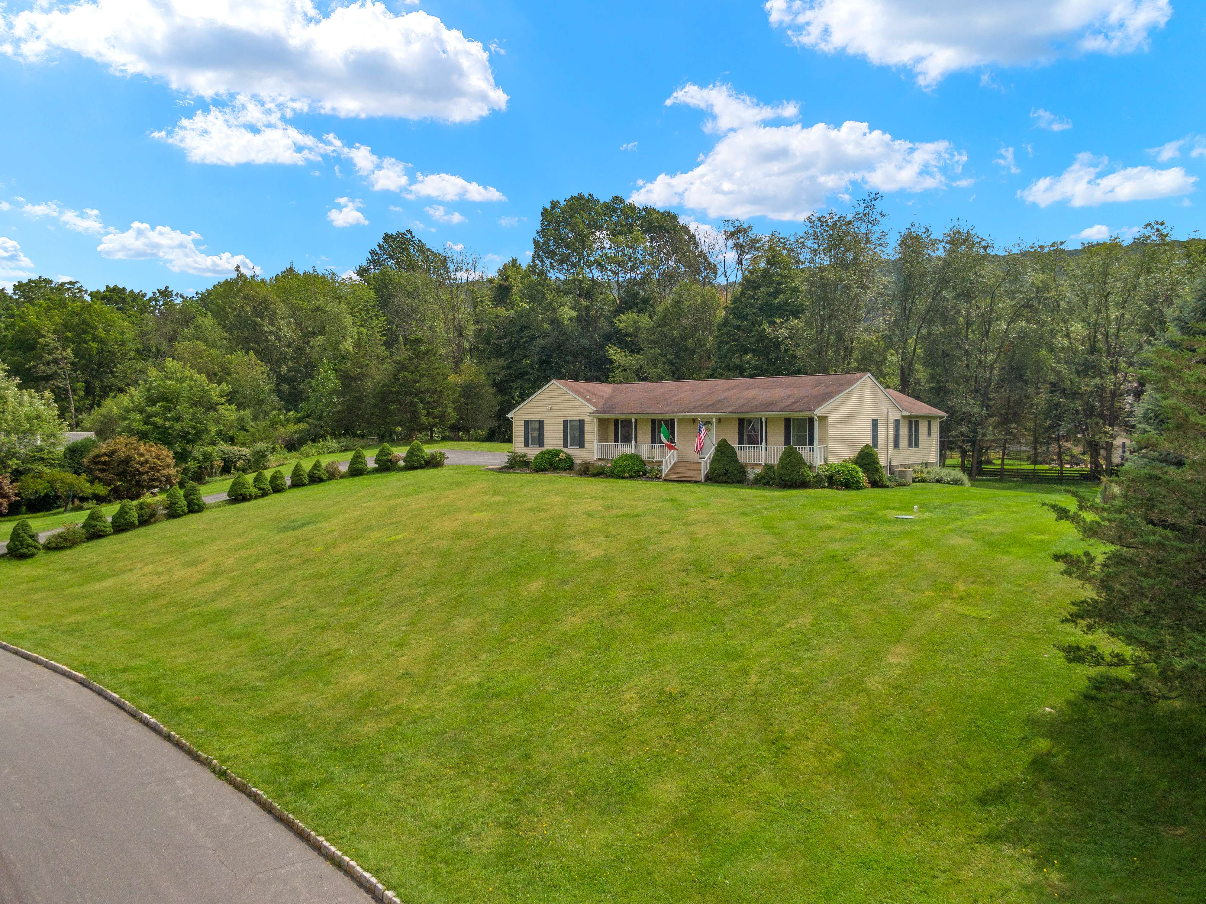 Aerial view of ranch home with large lawn