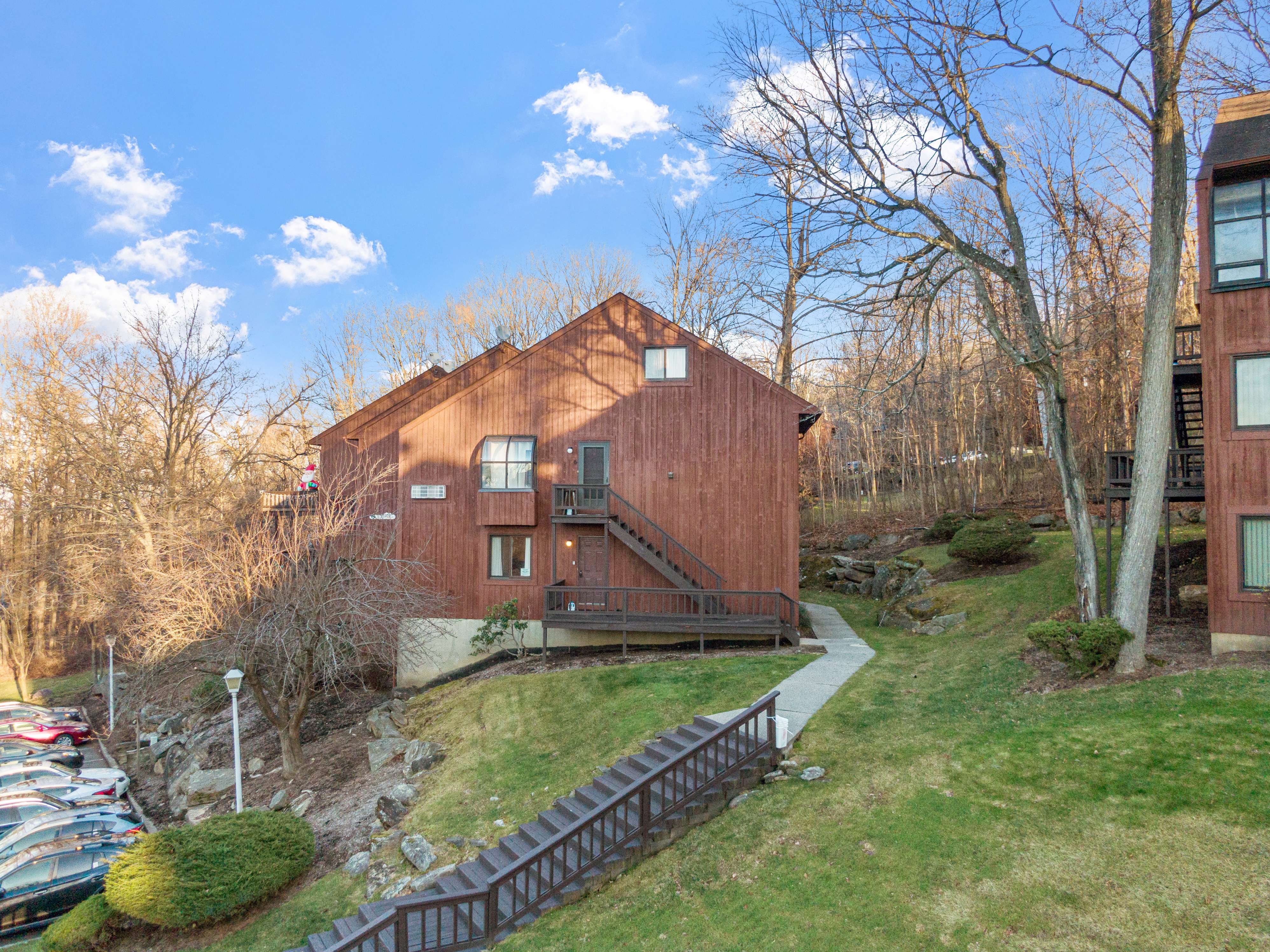Aerial view of wooden townhome with deck