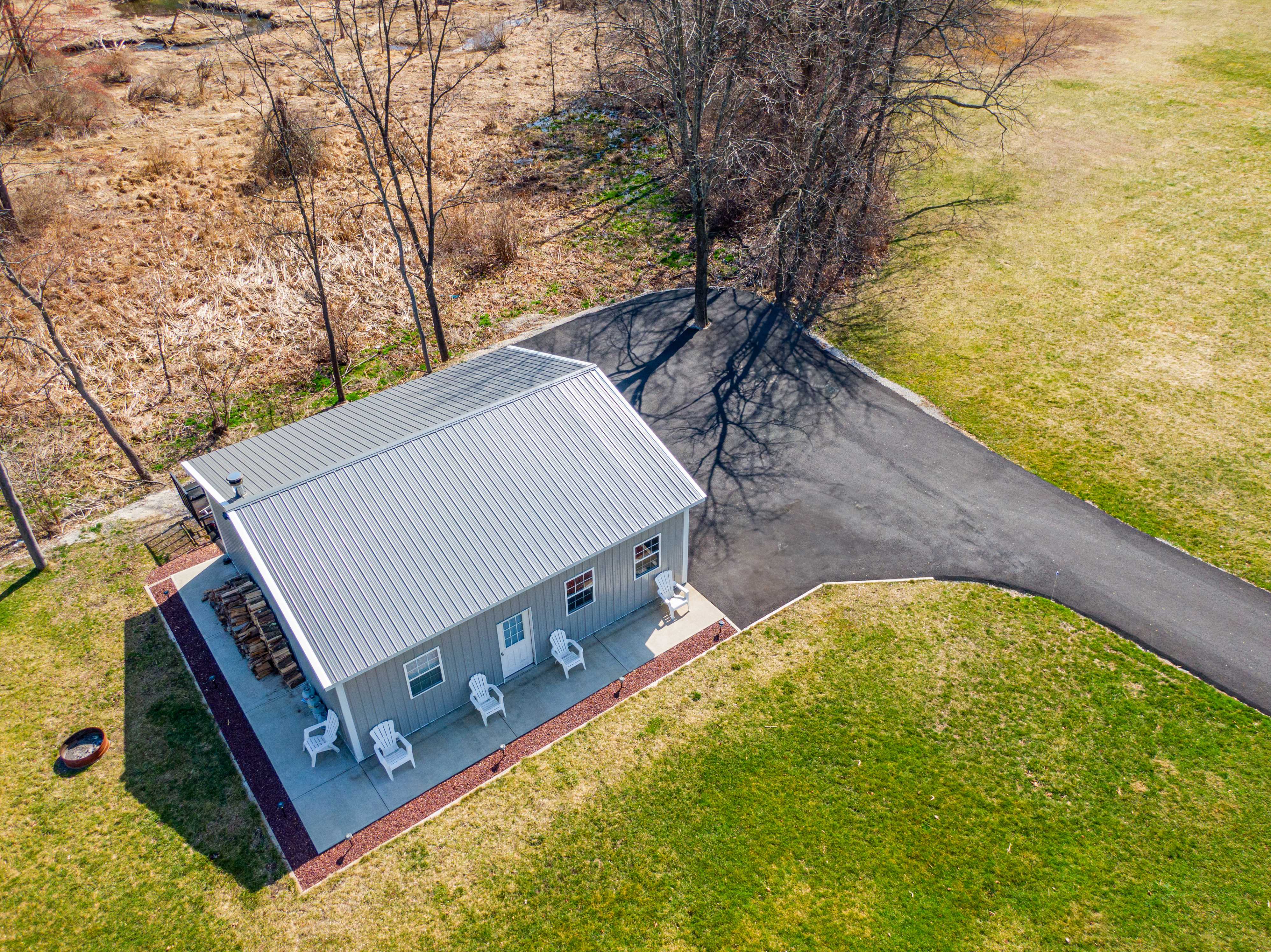 Aerial view of small home with patio