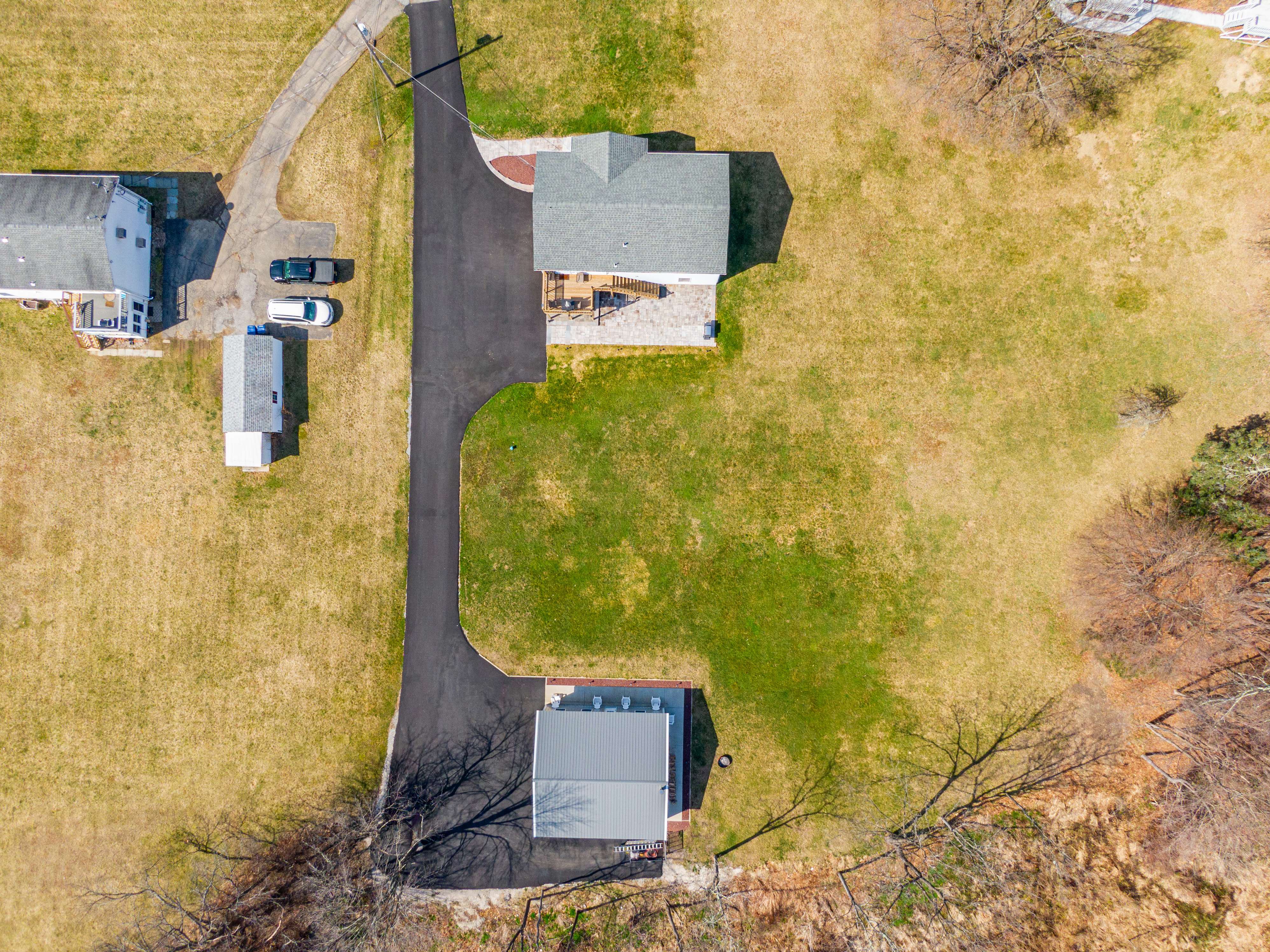 Top-down aerial view of property with long driveway