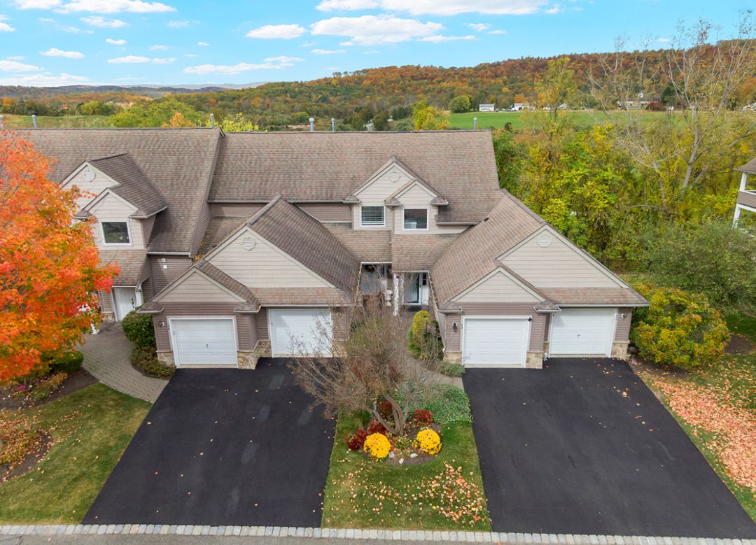 Aerial view of duplex homes with fall foliage