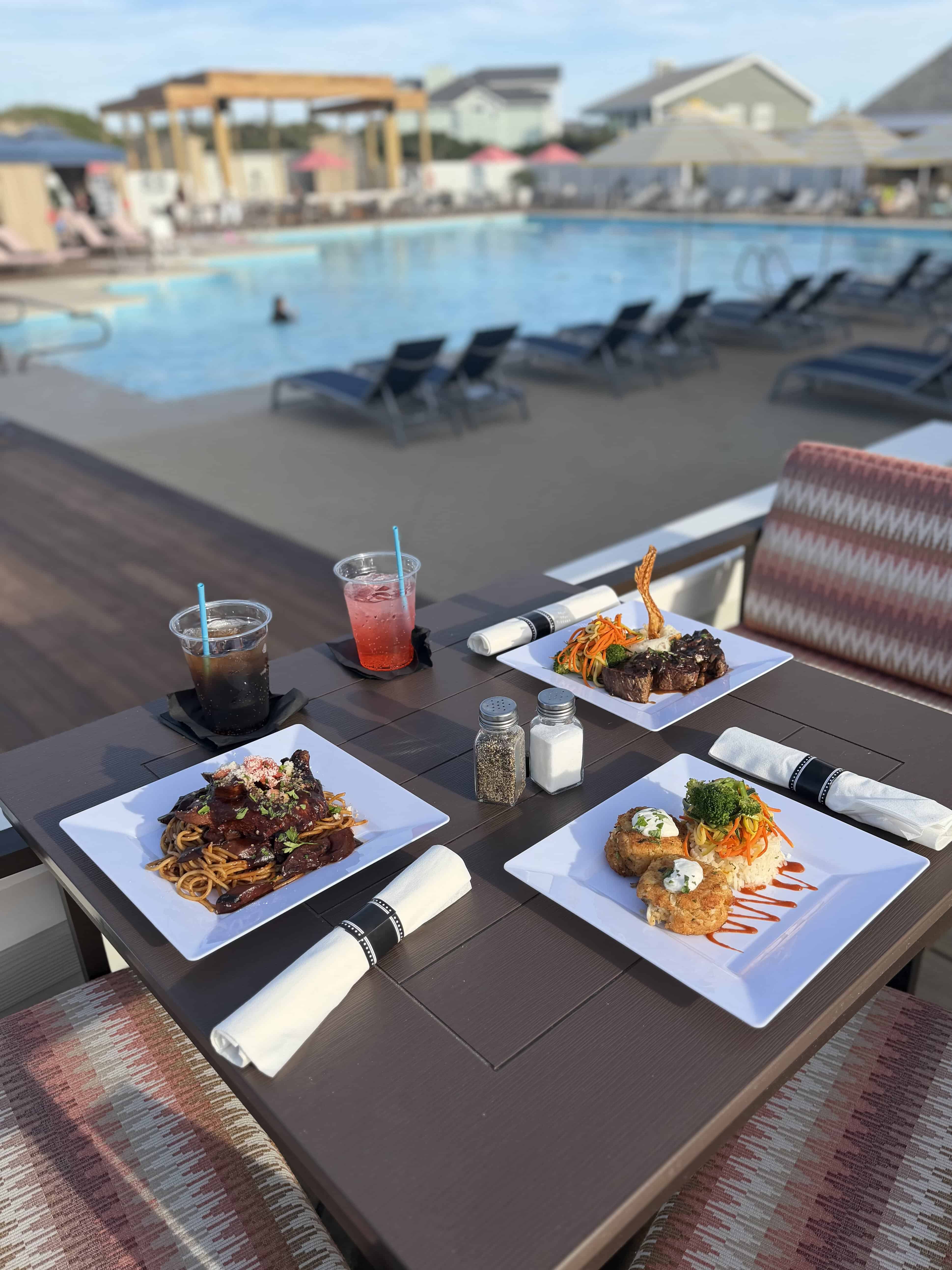 Plated entrees with colorful vegetables