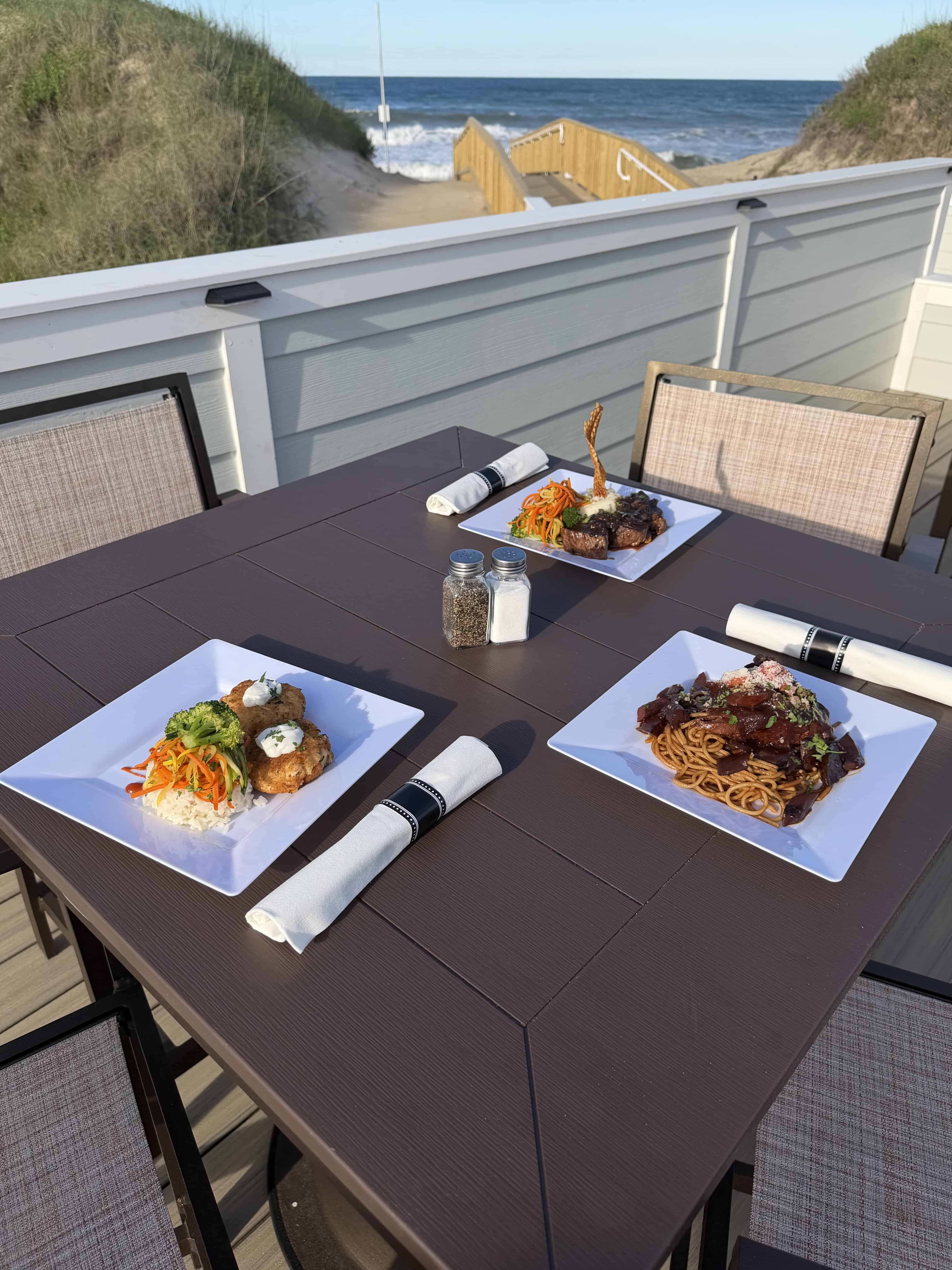 Oceanfront dinner table with plated entrees