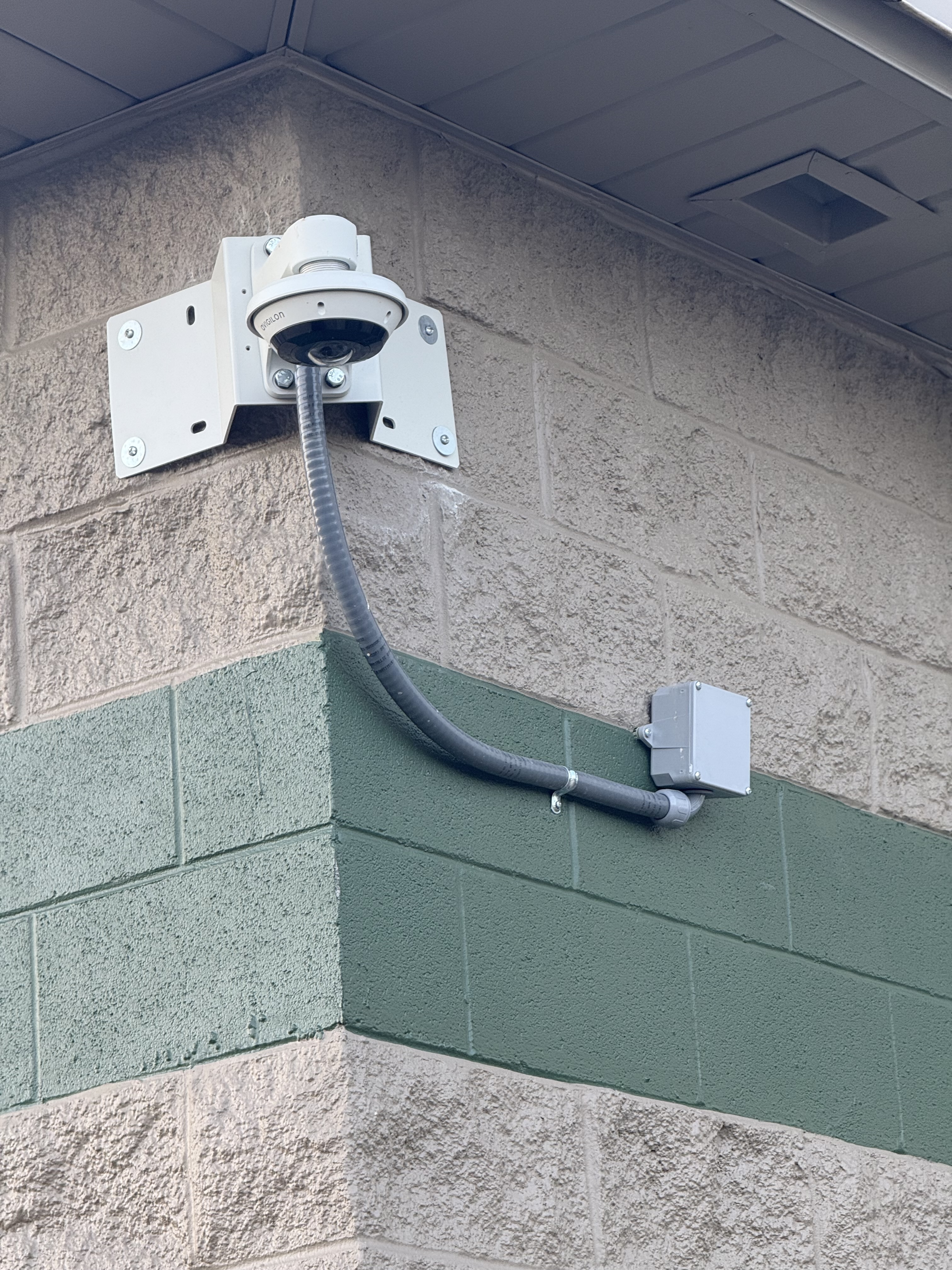 Commercial security camera installation with conduit and weatherproof mounting