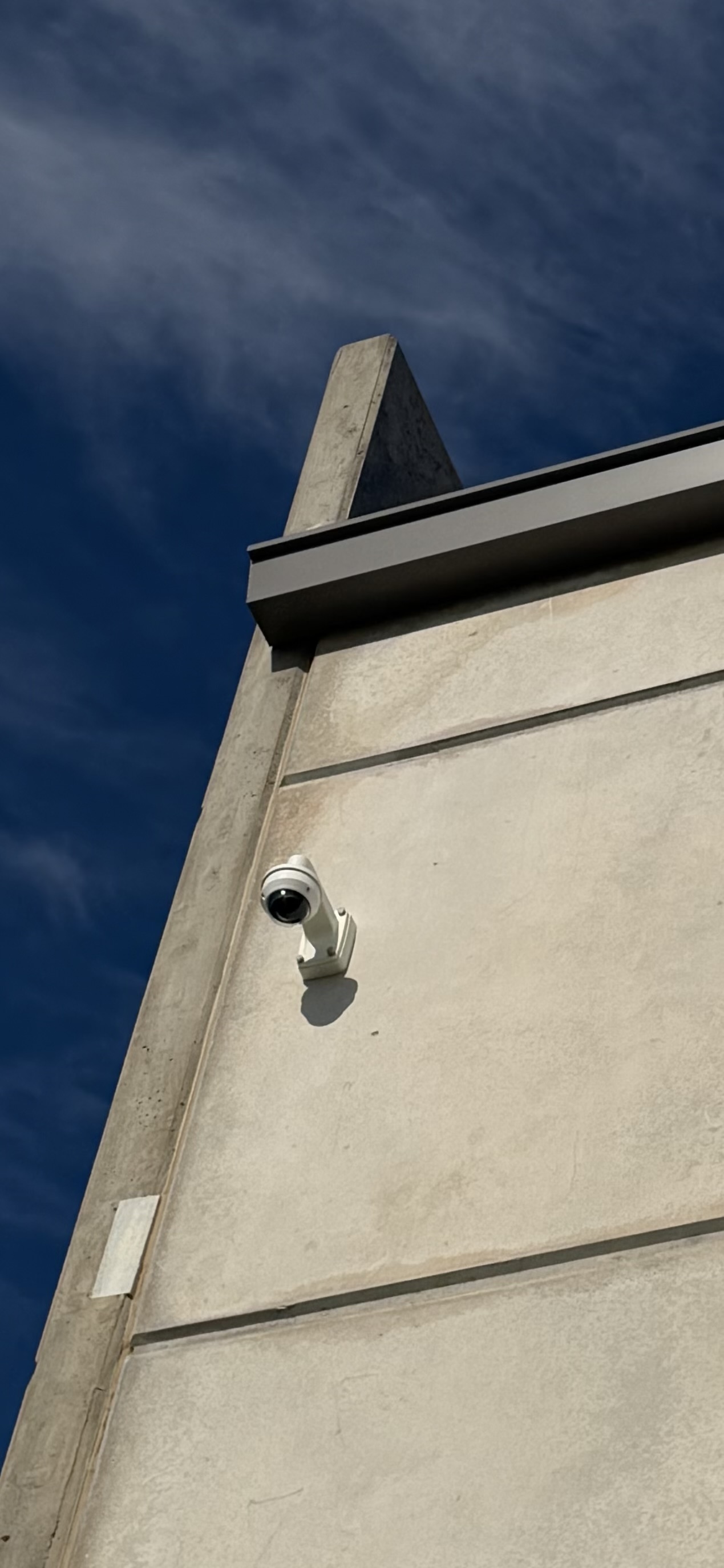 Exterior commercial security camera installed on building